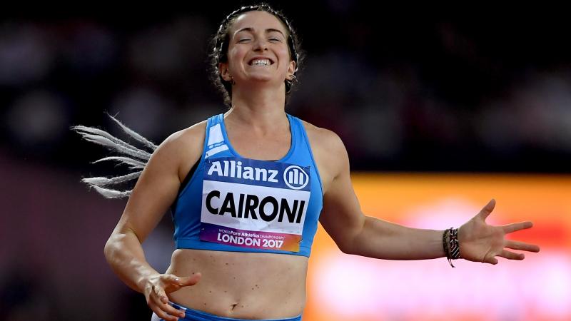 female Para sprinter Martina Caironi celebrates as she crosses the finish line