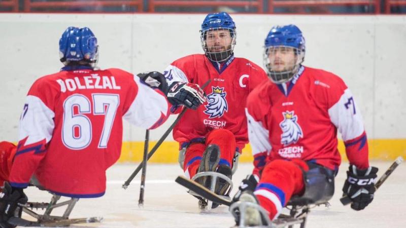 Three male Para ice hockey players on ice