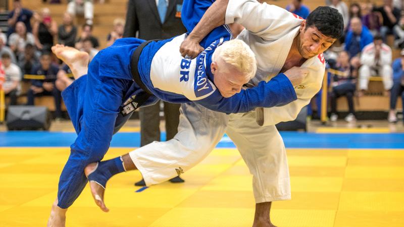 male judoka Ramil Gasimov wrestles another judoka to the ground