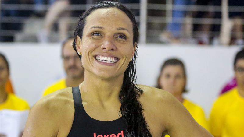 Maria Carolina Gomes smiling while wearing her swimsuit