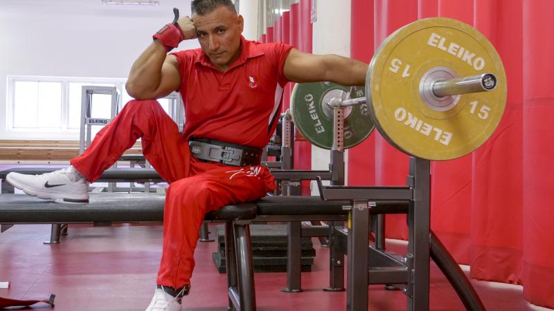 Peruvian powerlifter Niel Garcia Trelles poses on the benche staring at the camera