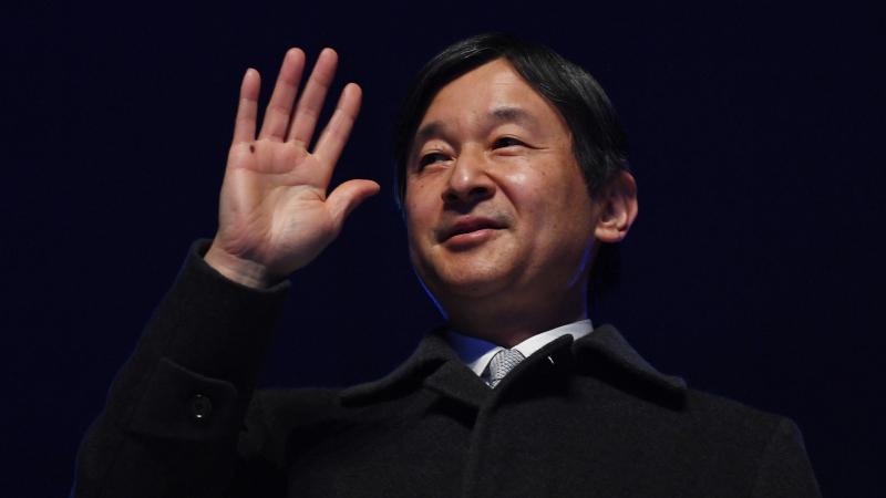 Emperor Naruhito of Japan waves to the crowd