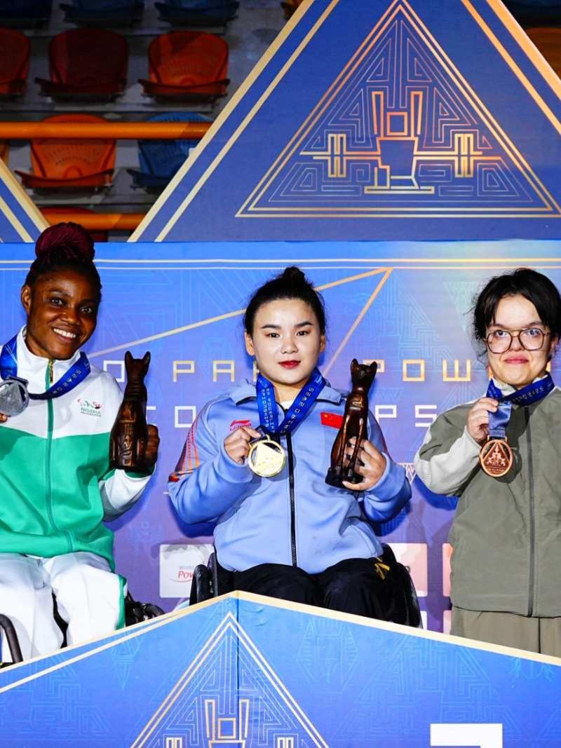 Players pose on the podium with their medals