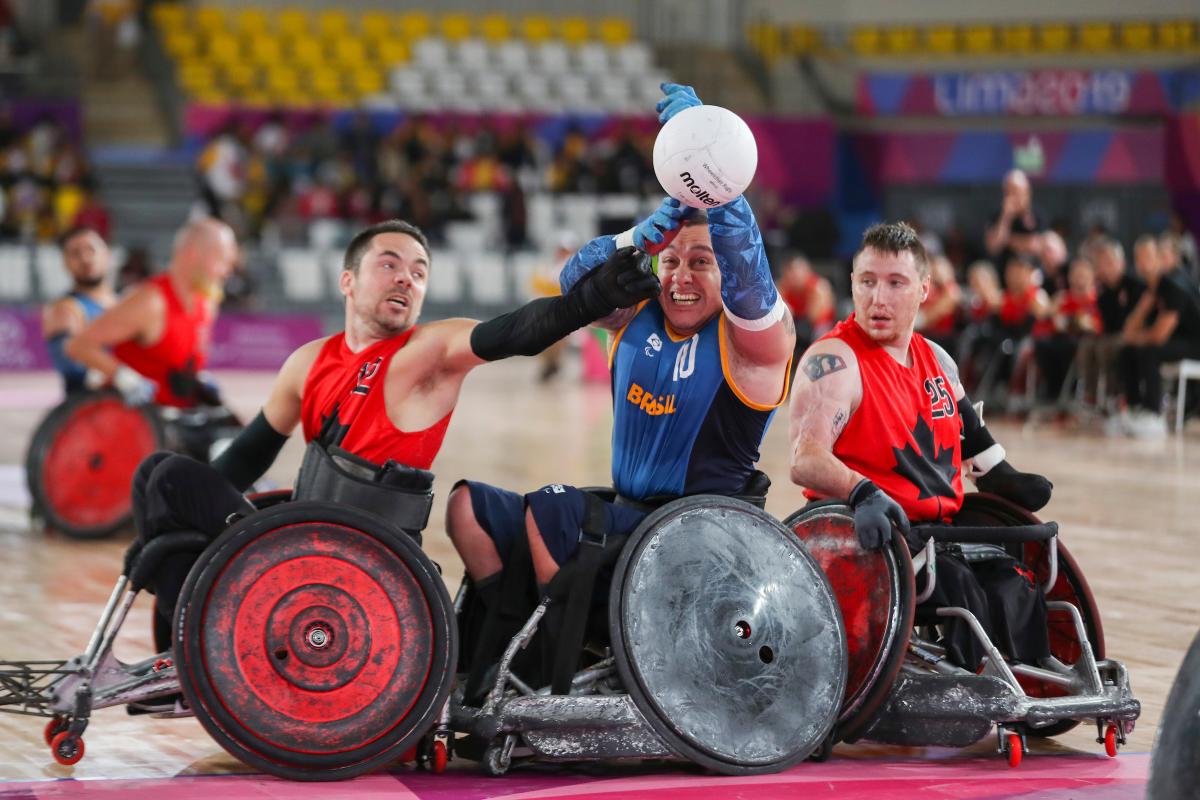 male wheelchair rugby players fight for the ball