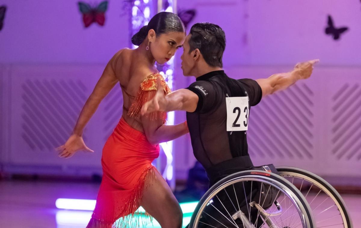 Female standing dancer dancers with male wheelchair dancer