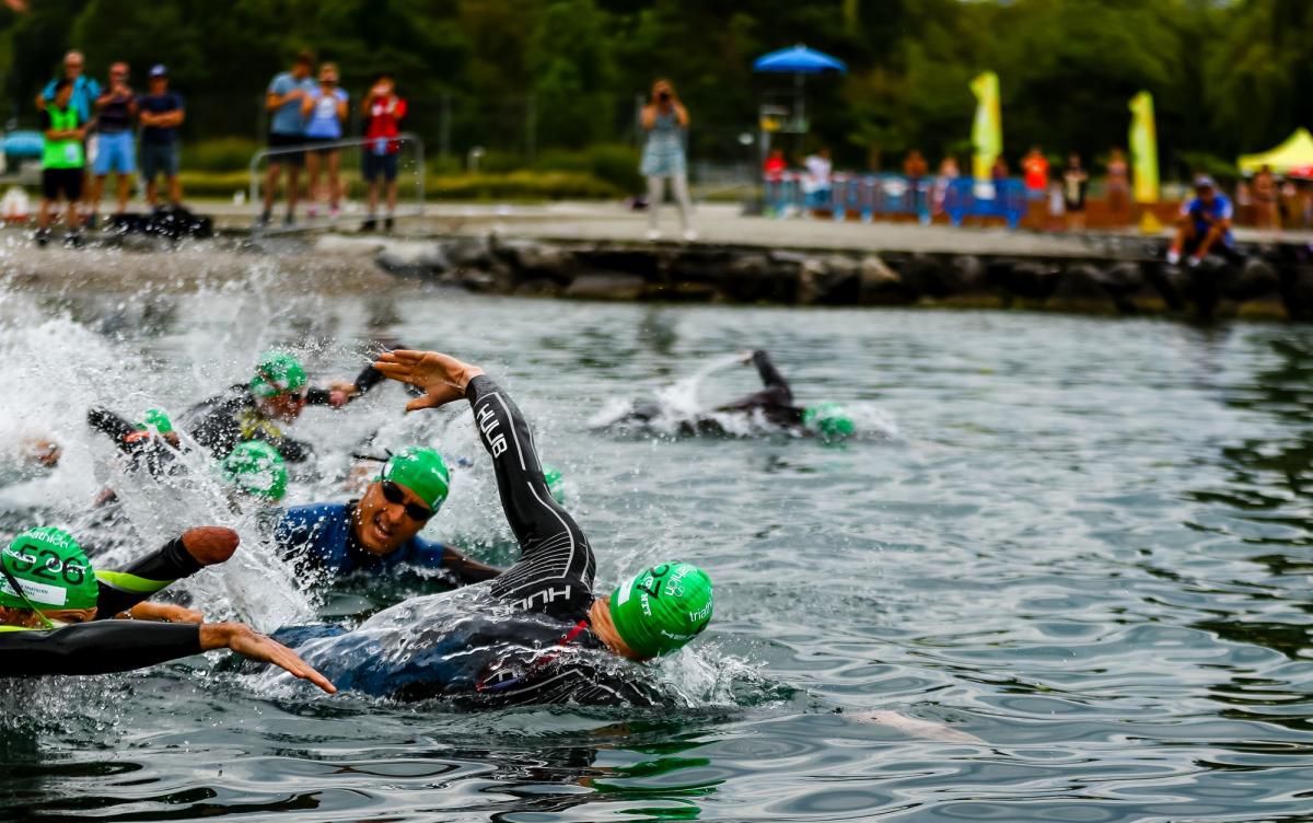 Triathletes swimming in open water