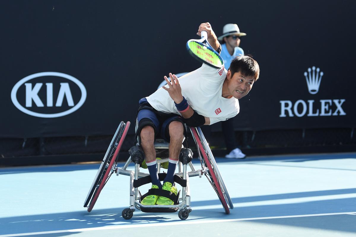 Japanese man in wheelchair hits a return shot in tennis