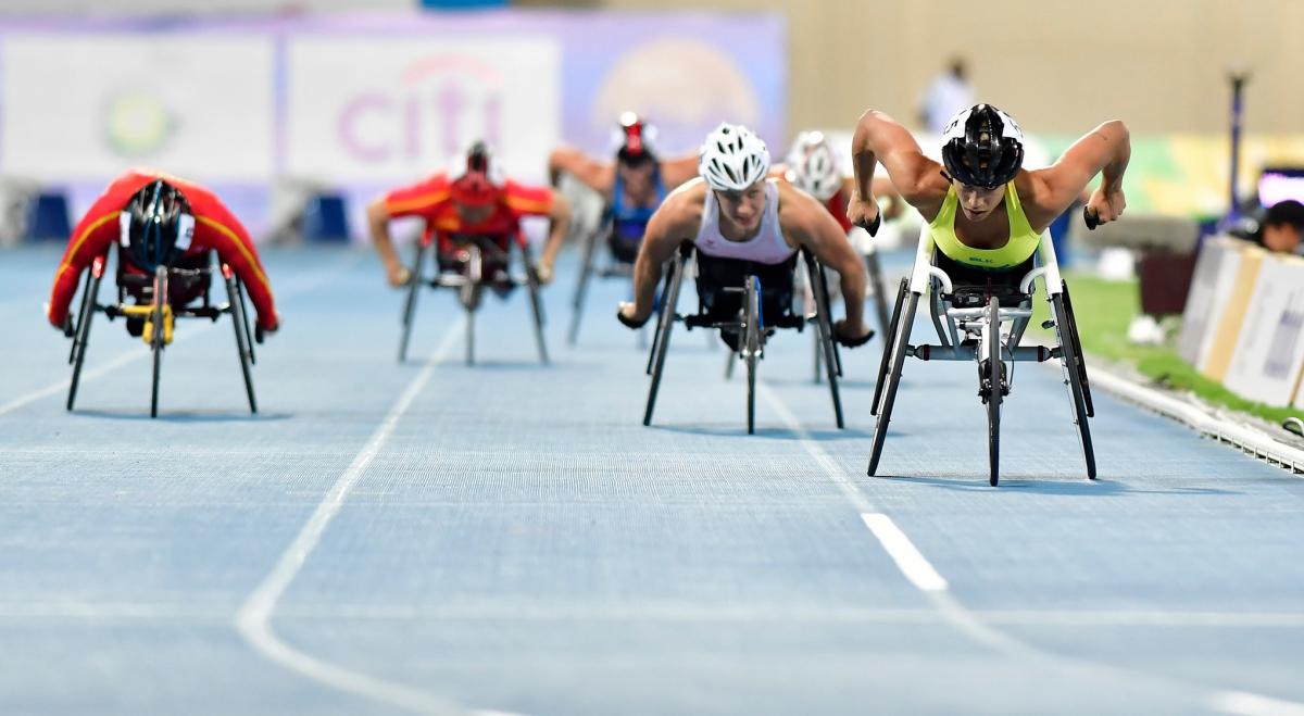 A group of female wheelchair racers on a track