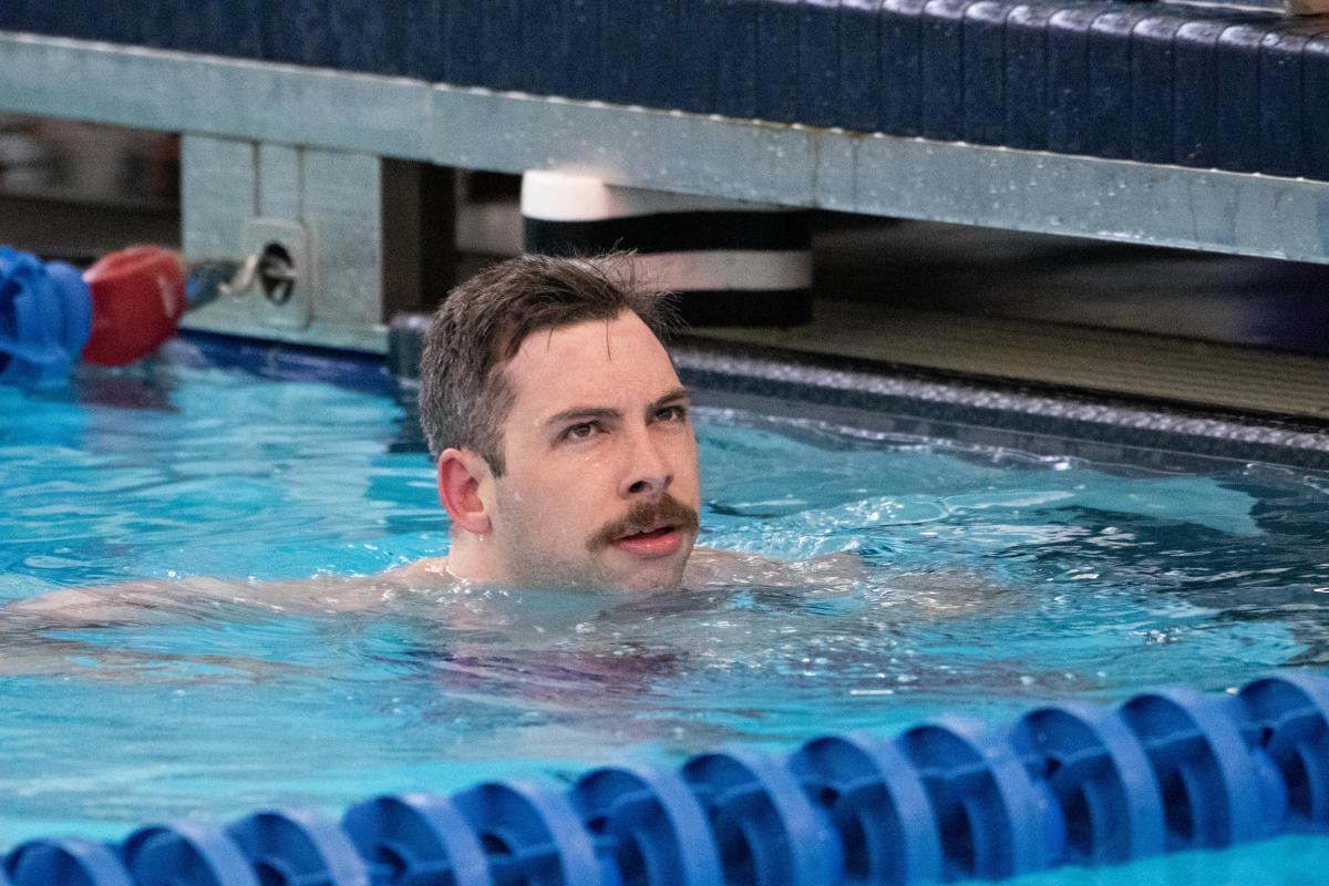 A male swimmer with a moustache in the swimming pool