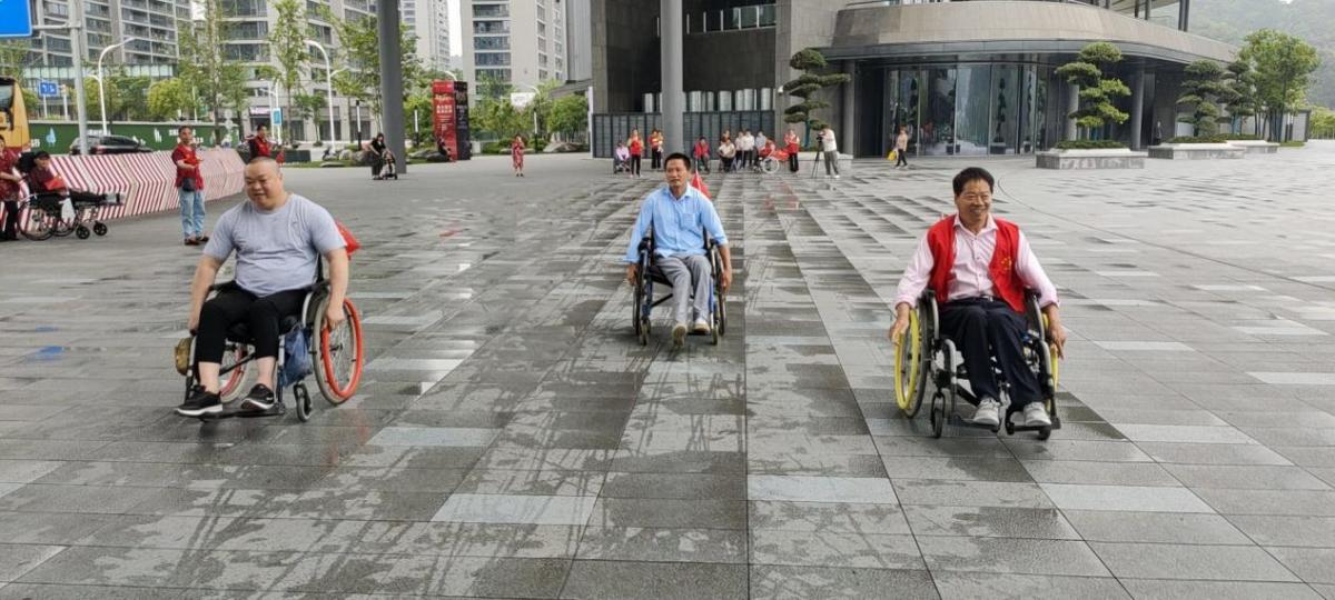 Three men in wheelchairs moving forward