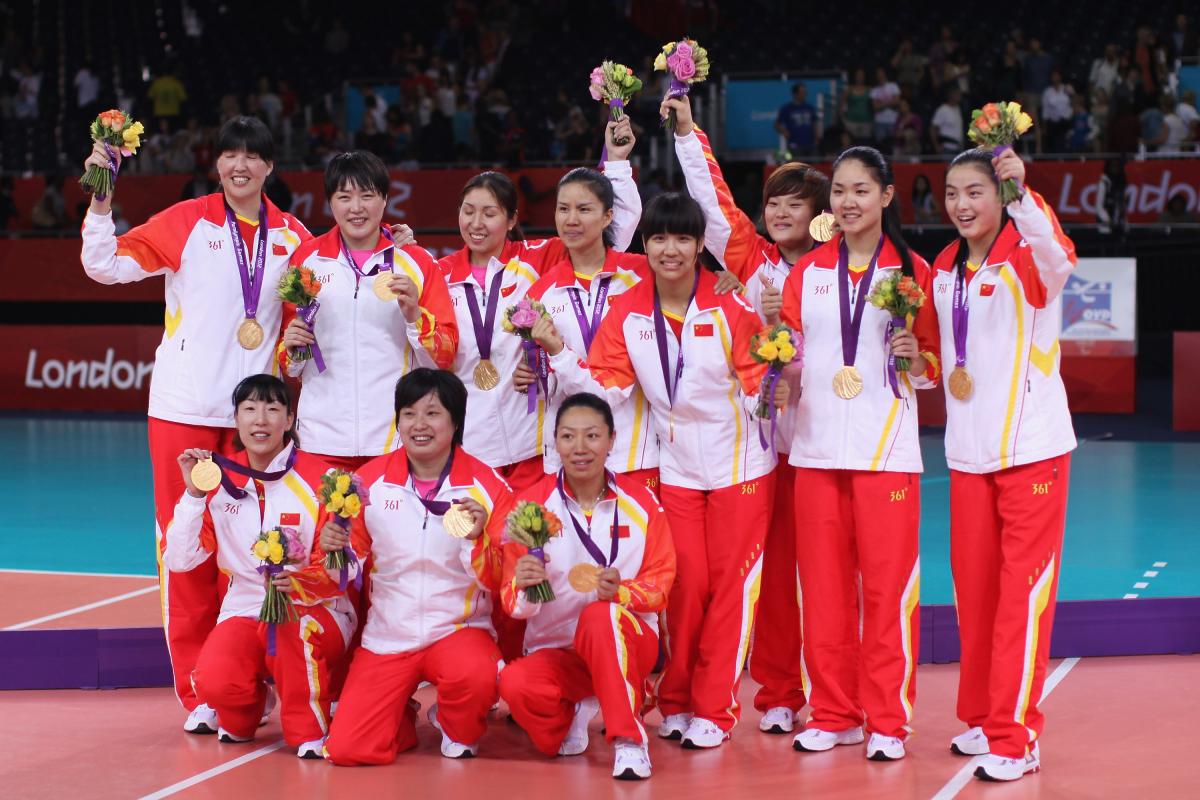 Chinese sitting volleyball team celebrates on the podium after winning gold at London 2012