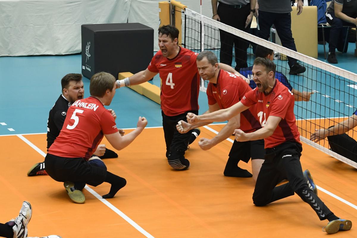 German sitting volleyball players celebrate on the court