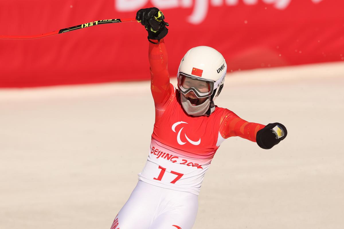 Zhang Mengqiu reacts with joy after finishing her race in Beijing
