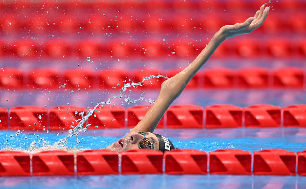 A male Para swimmer competing in a backstroke event