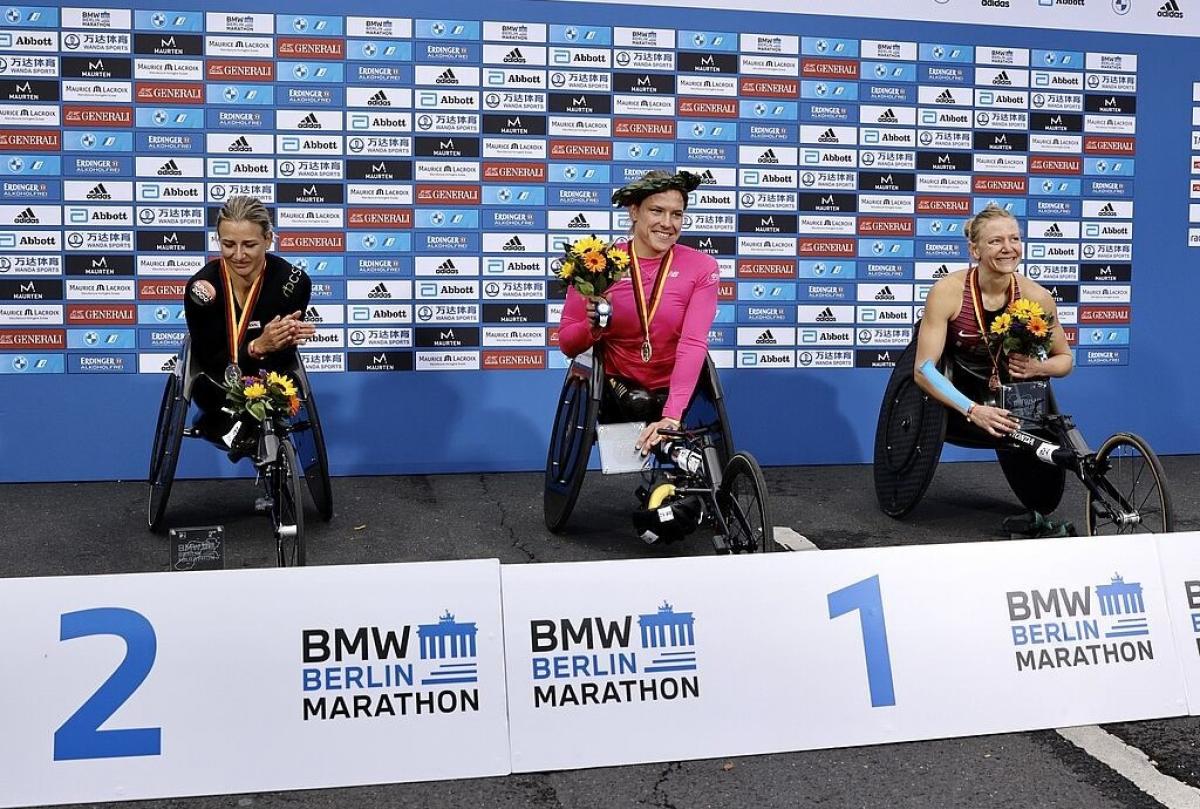 Three female wheelchair racers in the podium of the Berlin Marathon