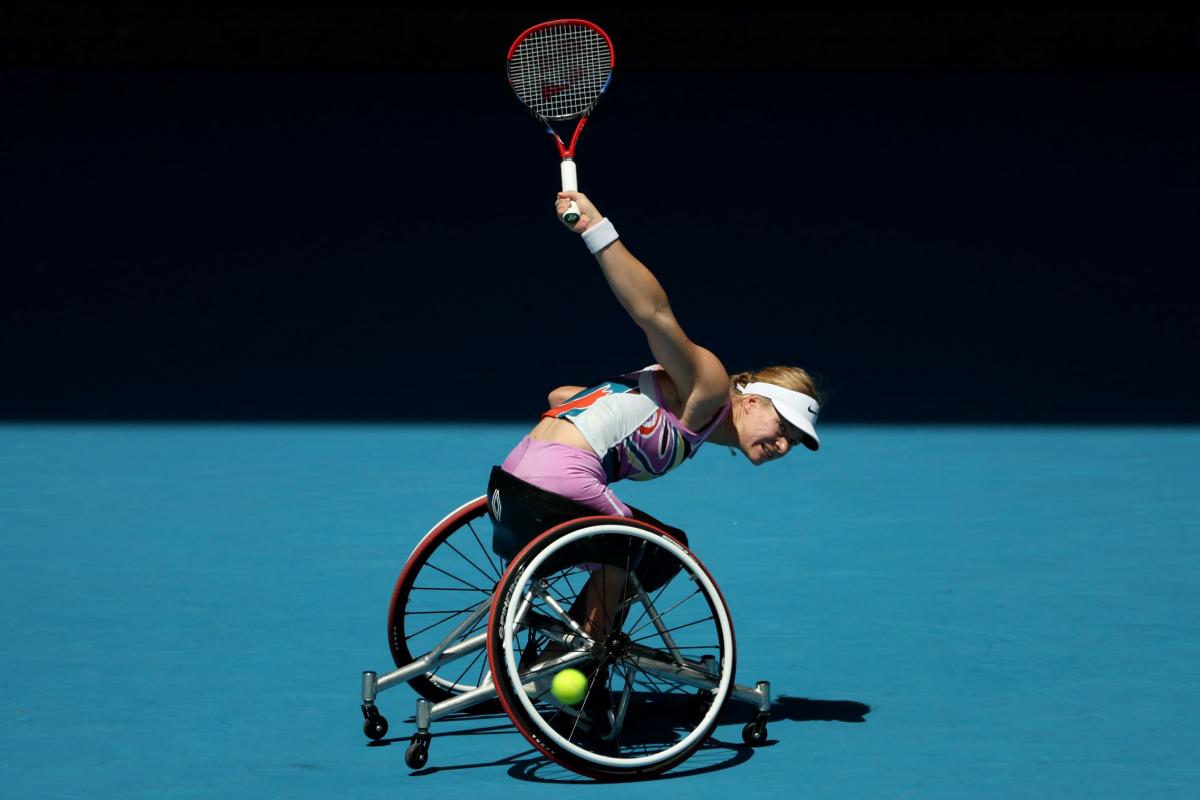 A female athlete plays a backhand in the women's singles final at the Australian Open.