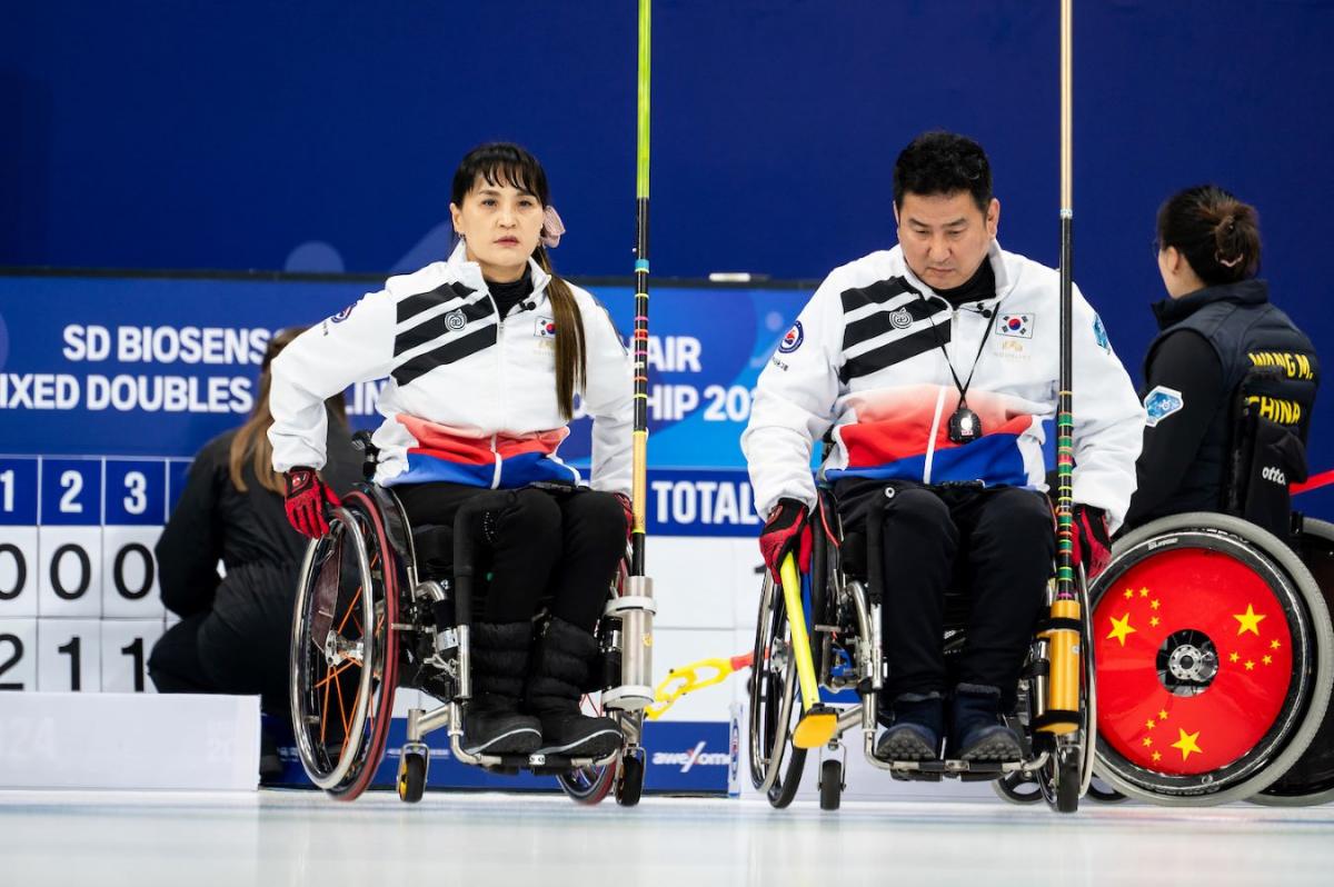 A male and a female wheelchair curlers take part in a competition