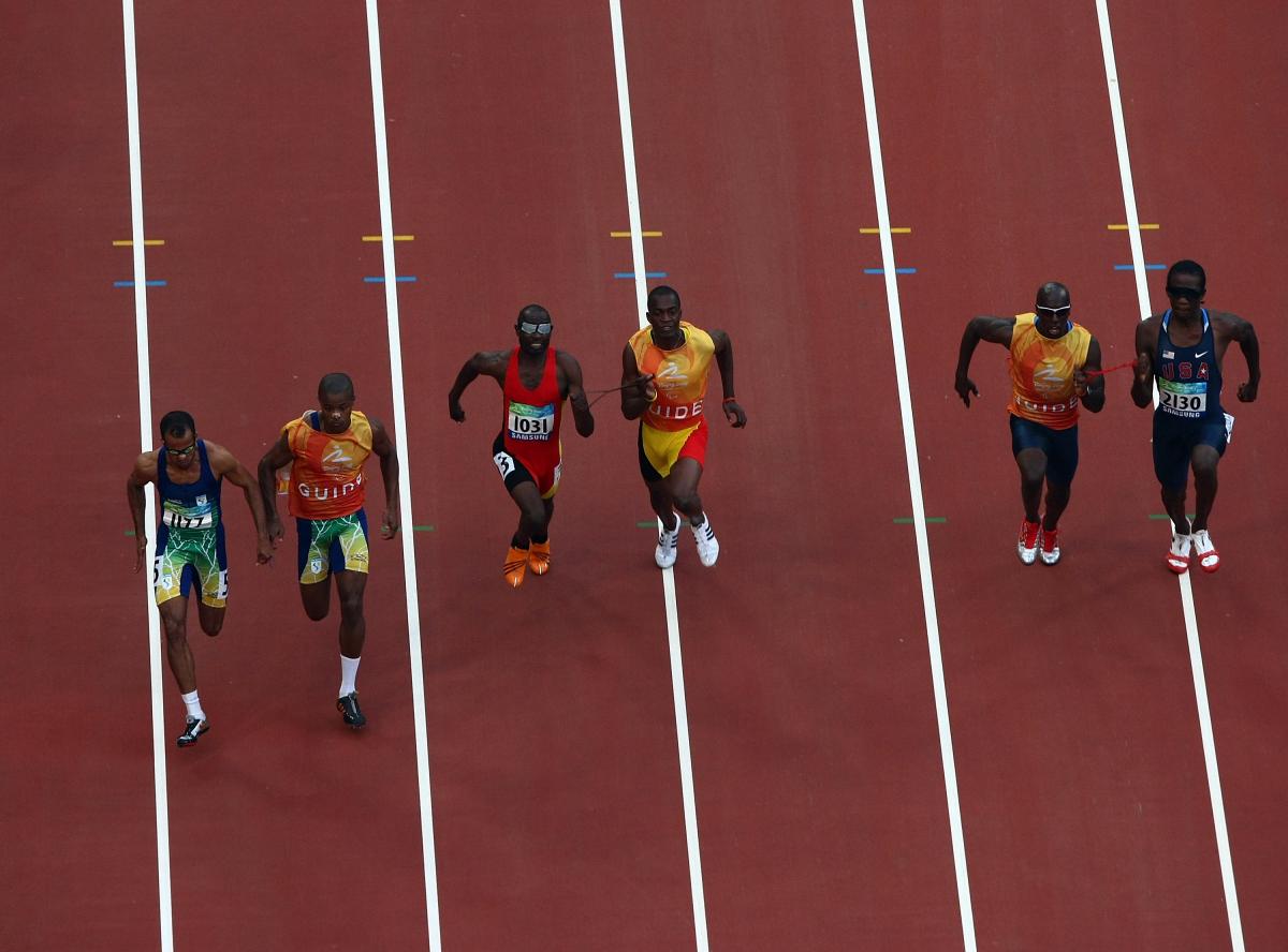 General view of athletes competing in the Men's 100m-T11