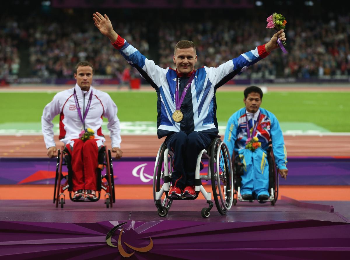 A picture of a men on a podium with medals around their neck