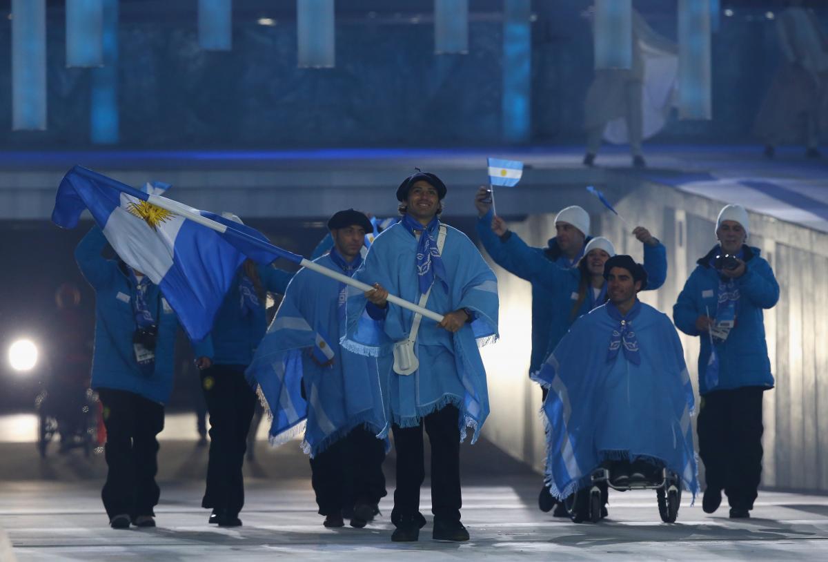 Argentina enter the arena lead by flag bearer Pablo Javier Robledo during the Opening Ceremony of the Sochi 2014 Paralympic Winter Games