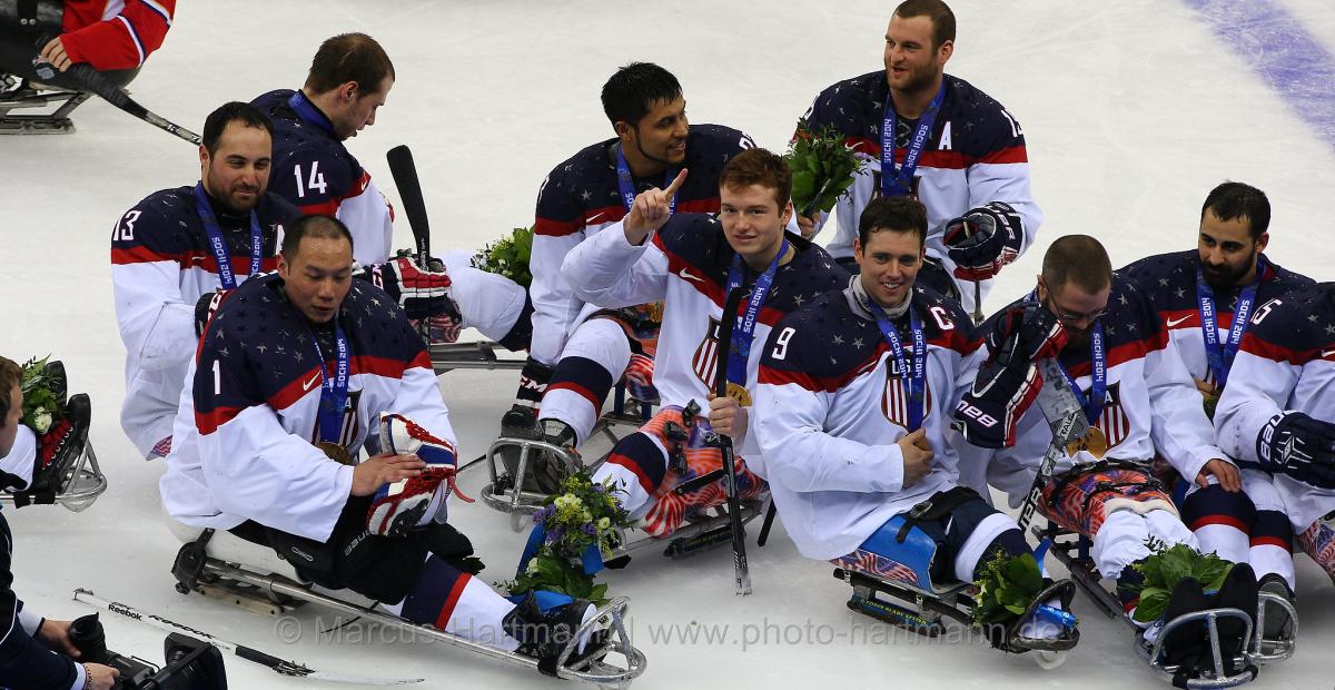 US players in their sledges on the ice after winning against Russia.
