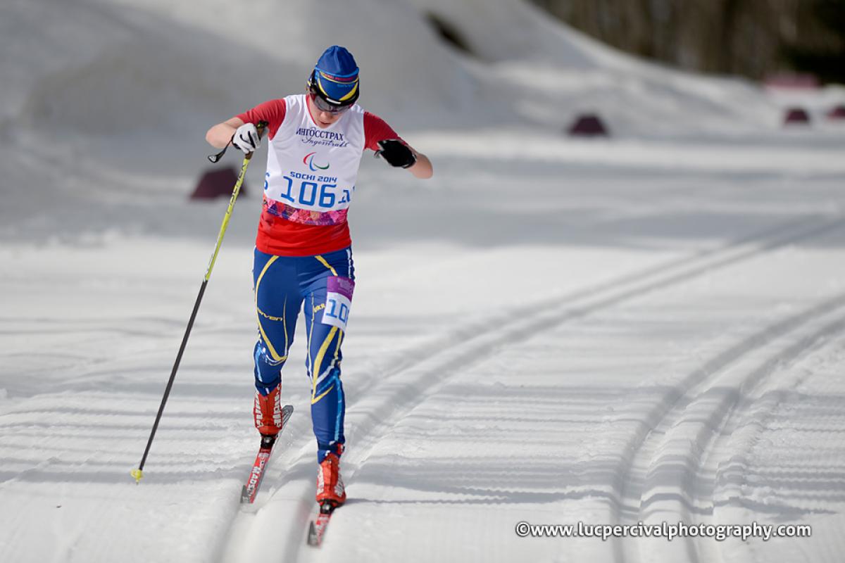 Cross country skier in race suit in a slope