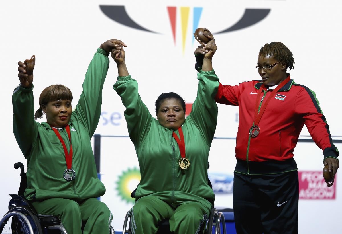 Loveline Obiji, Bose Omolayo, Joyce Wambui Glasgow 2014 Three heavyweight female powerlifters on the podium at Glasgow 2014.
