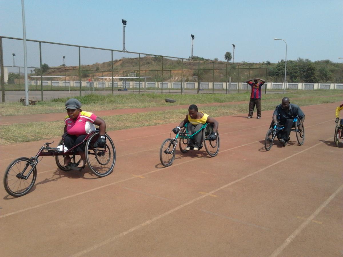 A Ugandan athlete tries out a racing wheelchair