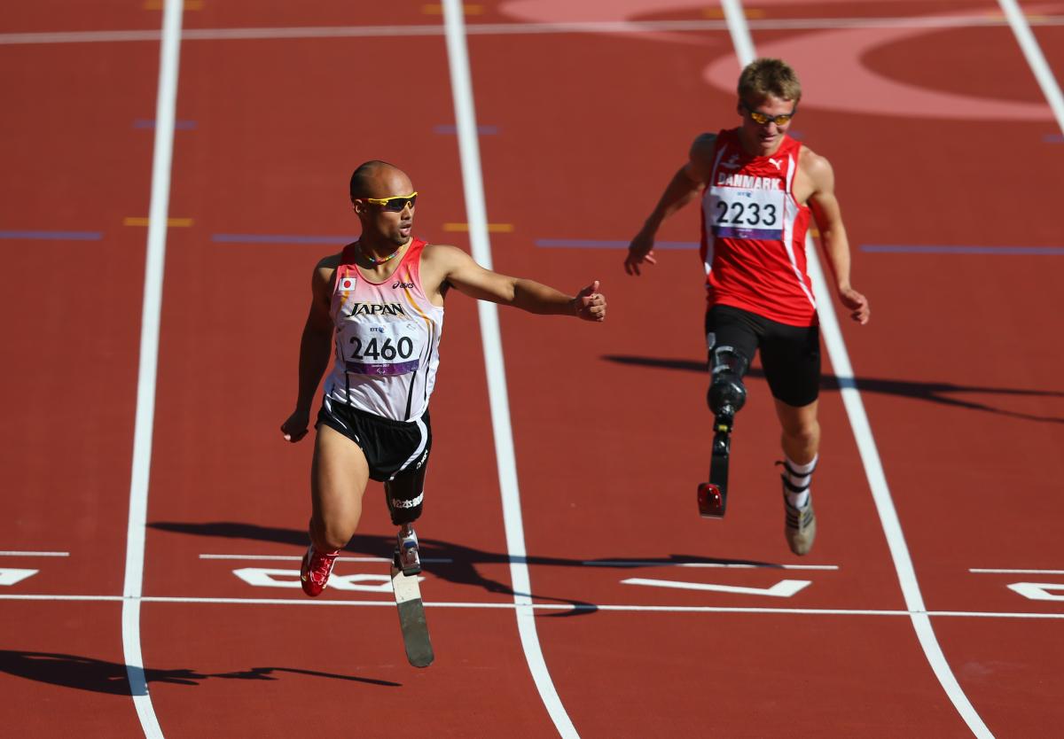 Atsushi Yamamoto of Japan and Daniel Jorgensen of Denmark compete in the men's 100m T42 heats at London 2012