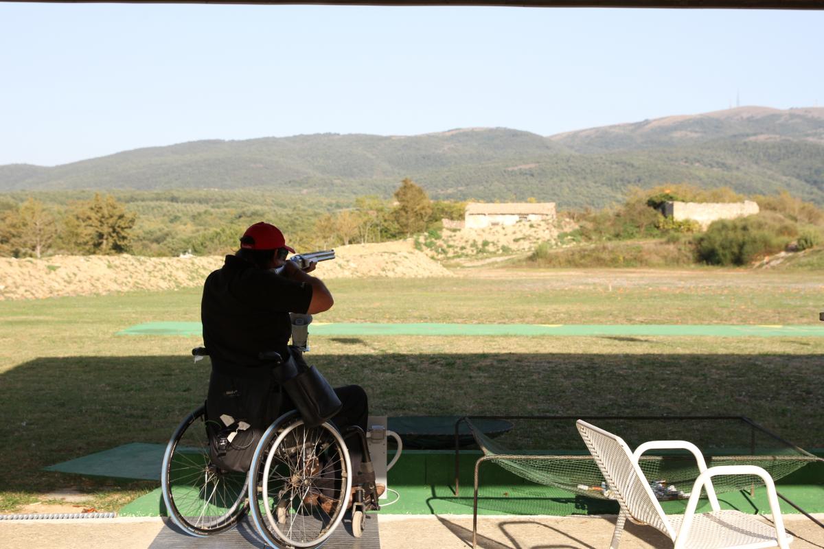 Man in wheelchair targets. Nice landscape in the background