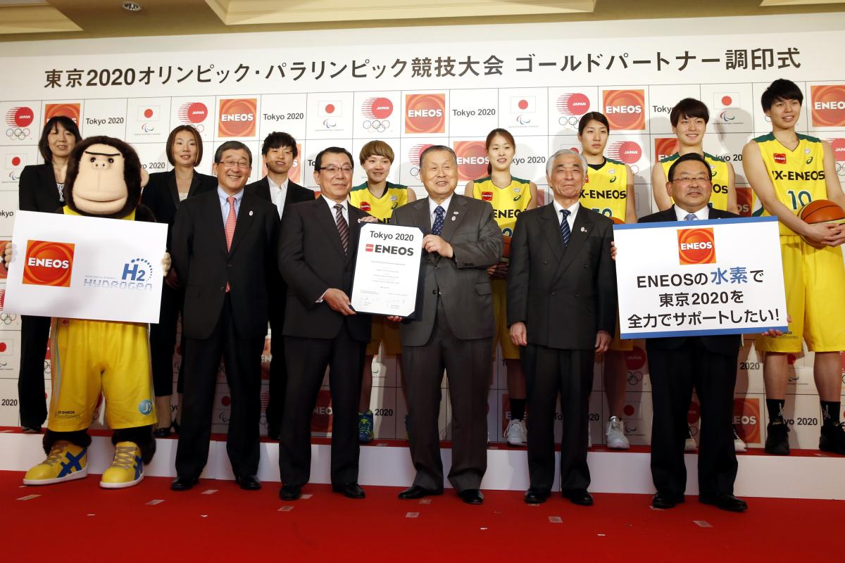 Group shot of people wearing suits and athletes