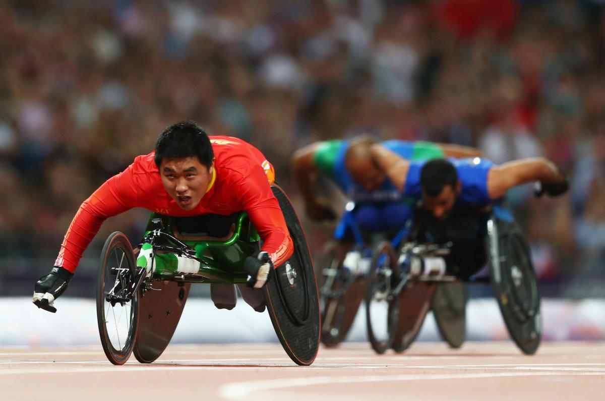 Huzhao Li of China crosses the line to win gold in the Men's 200m T53 Final at the London 2012 Paralympic Games.