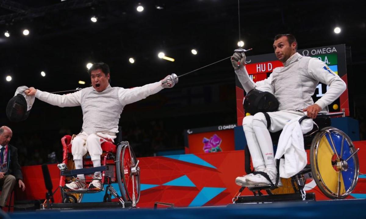 Daoliang Hu of China Daoliang Hu (L) of China celebrates winning gold against Anton Datsko (R) of Ukraine during the Men's Individual Foil Category B final of the Wheelchair Fencing on day 6 of the London 2012 Paralympic Games.