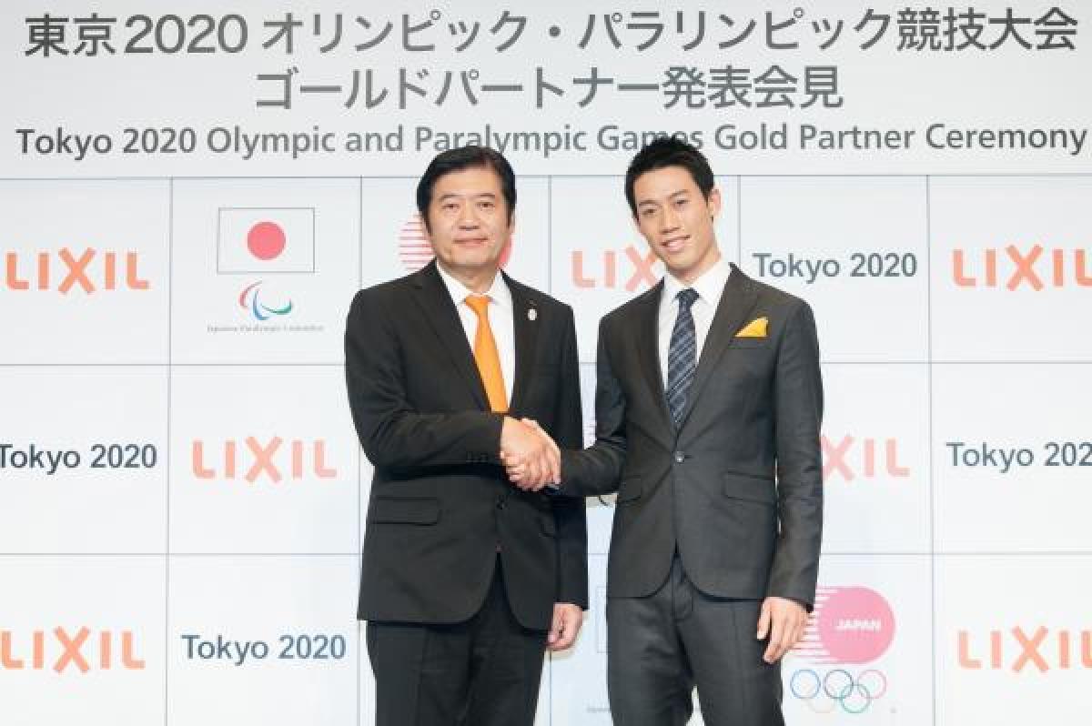 Two men shaking hands after sponsorship deal