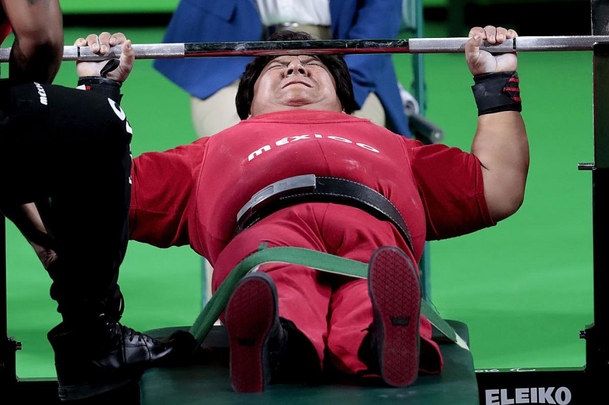female powerlifter on bench preparing to lift weights
