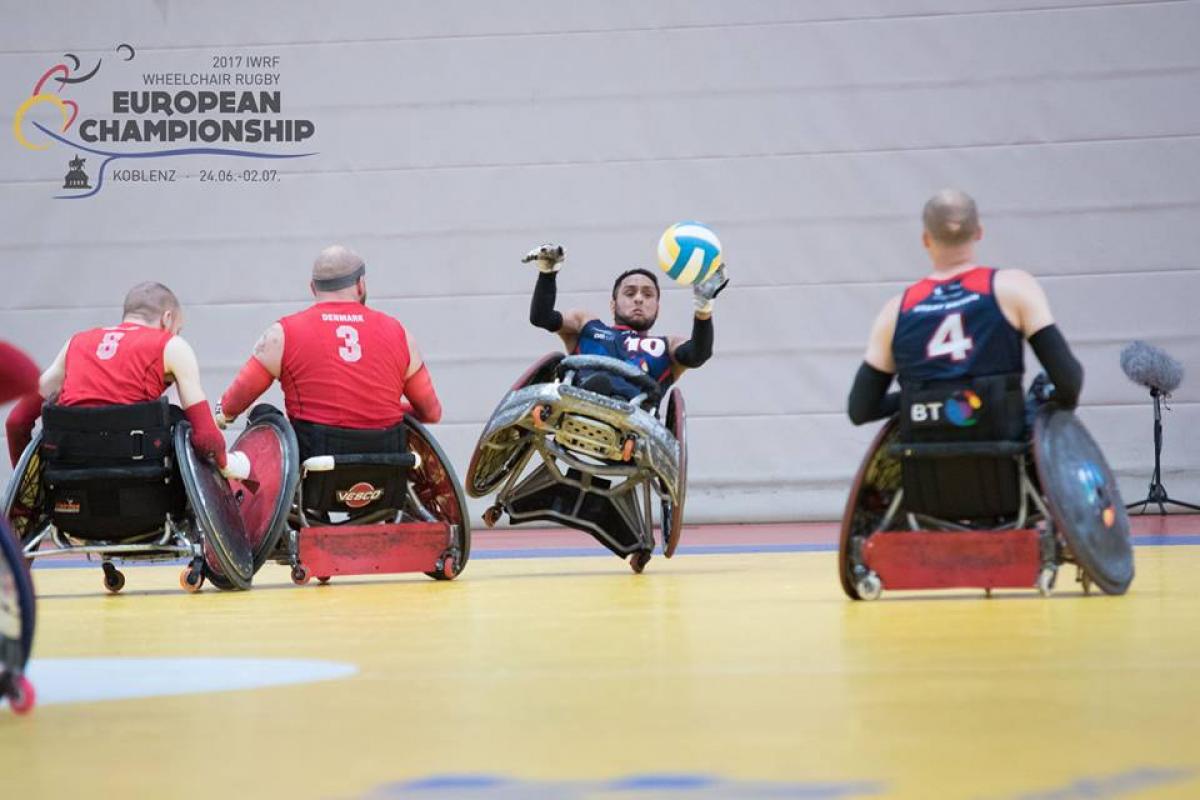 men tackle for the ball in wheelchairs