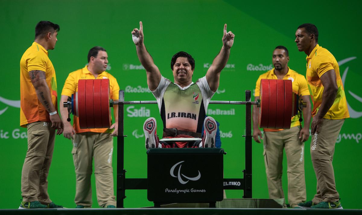 a Para powerlifter celebrates on the bench