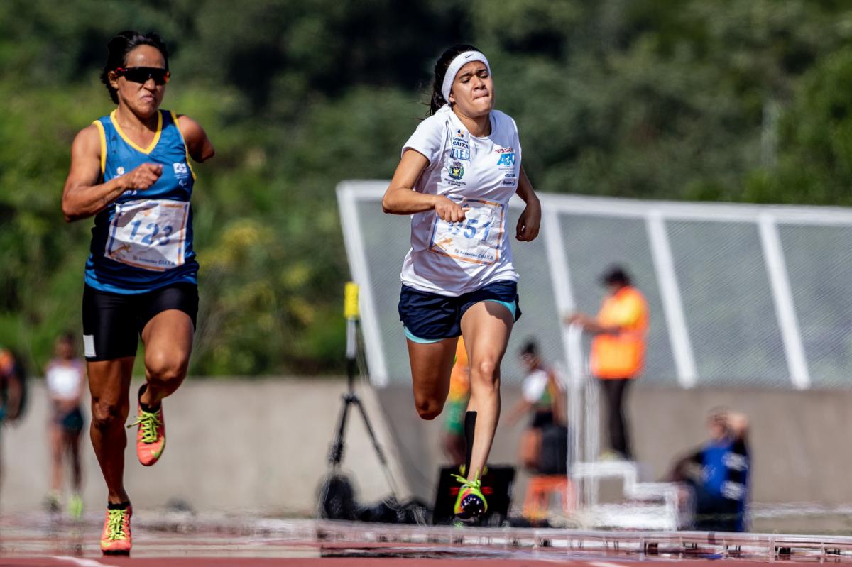 a female Para sprinter runs for the line