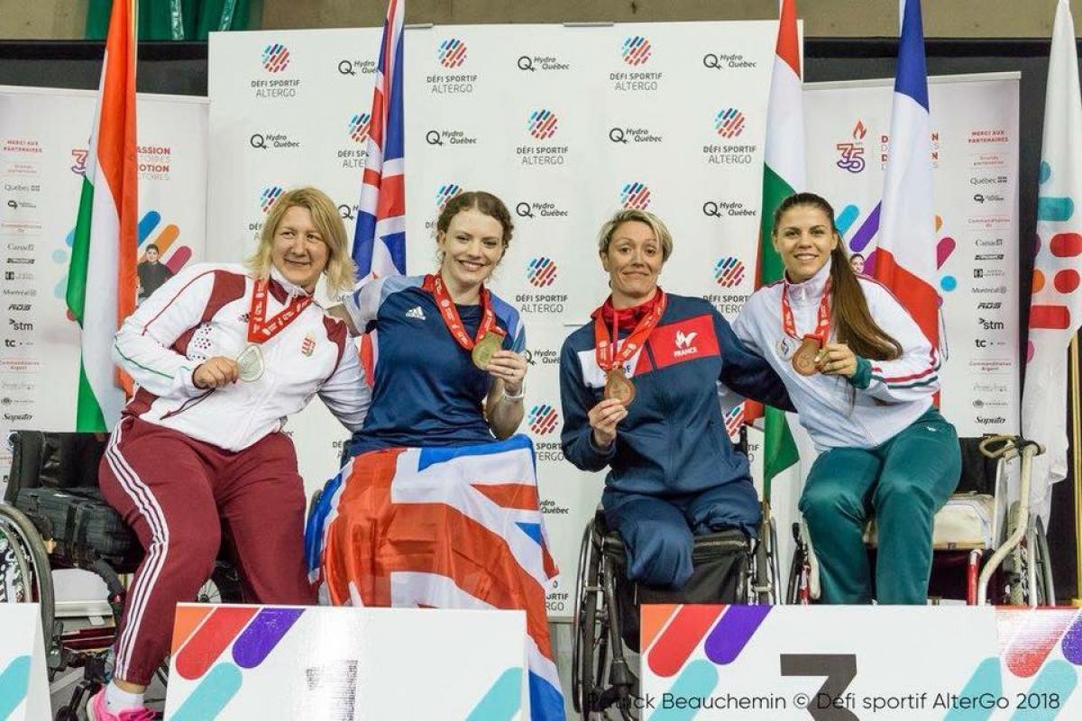 a group of female wheelchair fencers in a row