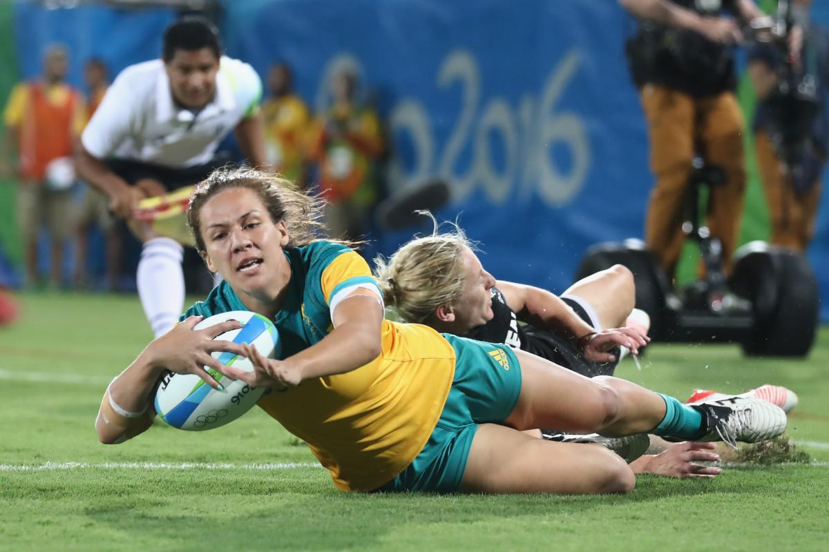 a female rugby player scores a try