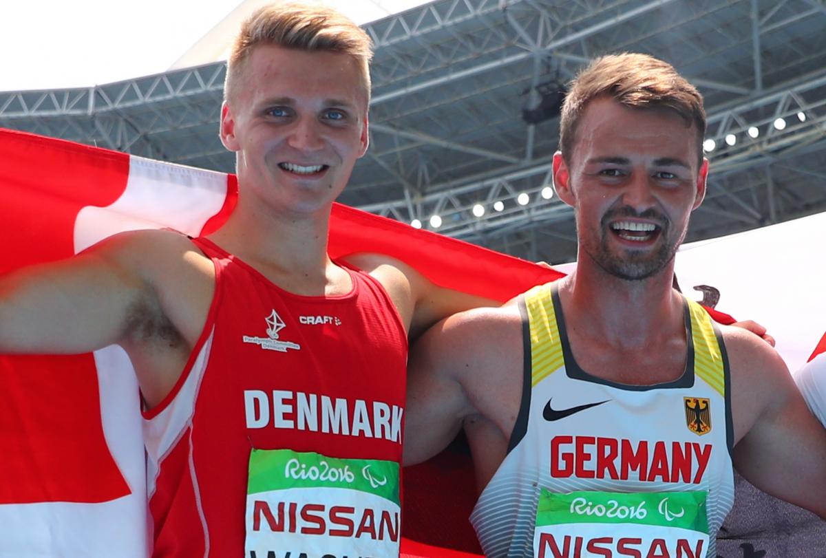 male Para athletes Daniel Wagner and Heinrich Popow smiling with their arms around eachother