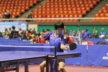 A chinese person playing Table Tennis