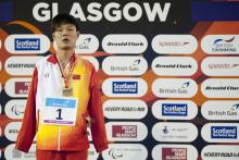 Tao Zheng of China on the podium after the Men's 50m Butterfly S6 at the 2015 IPC Swimming World Championships in Glasgow