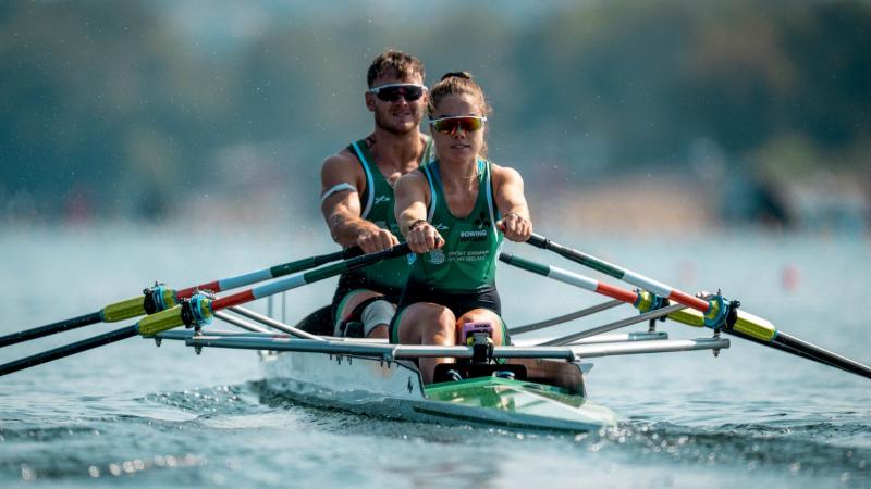 A female and male Para rowers competing.