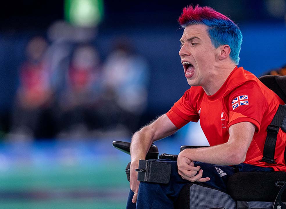 David Smith shouts as during his gold medal game. He has a red and blue mohawk