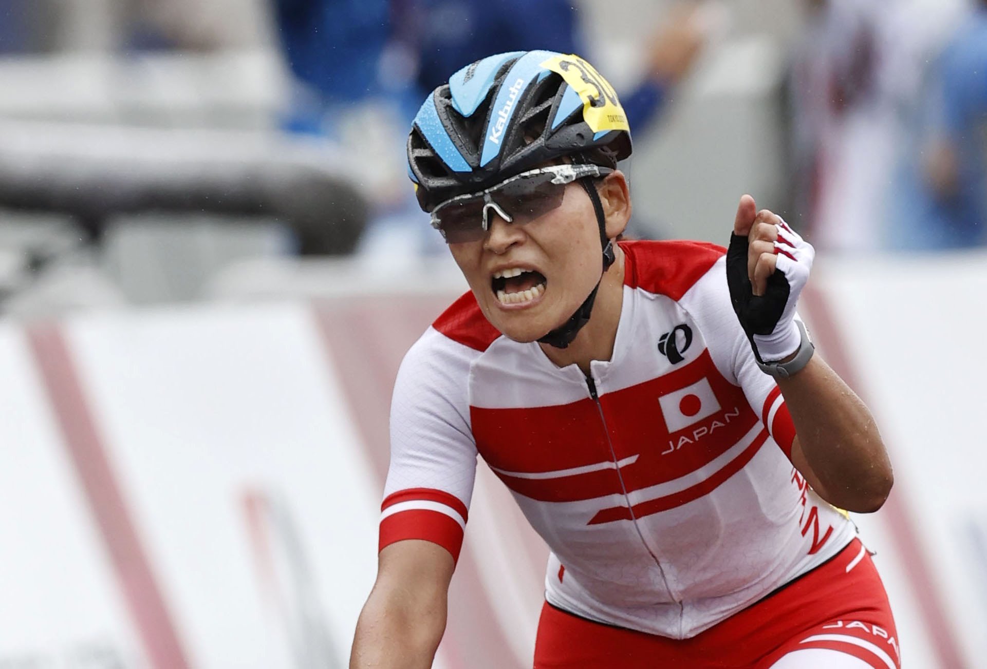 Fist clenched, close up of Keiko Sugiura cycling to gold