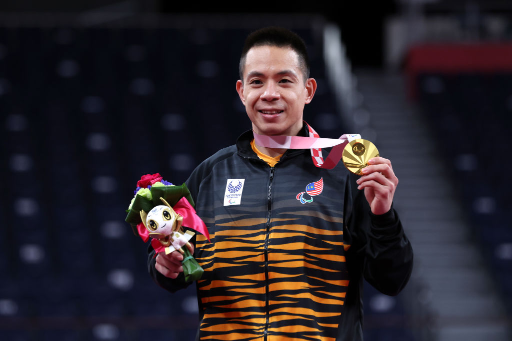 Malaysian man smiles with gold medal
