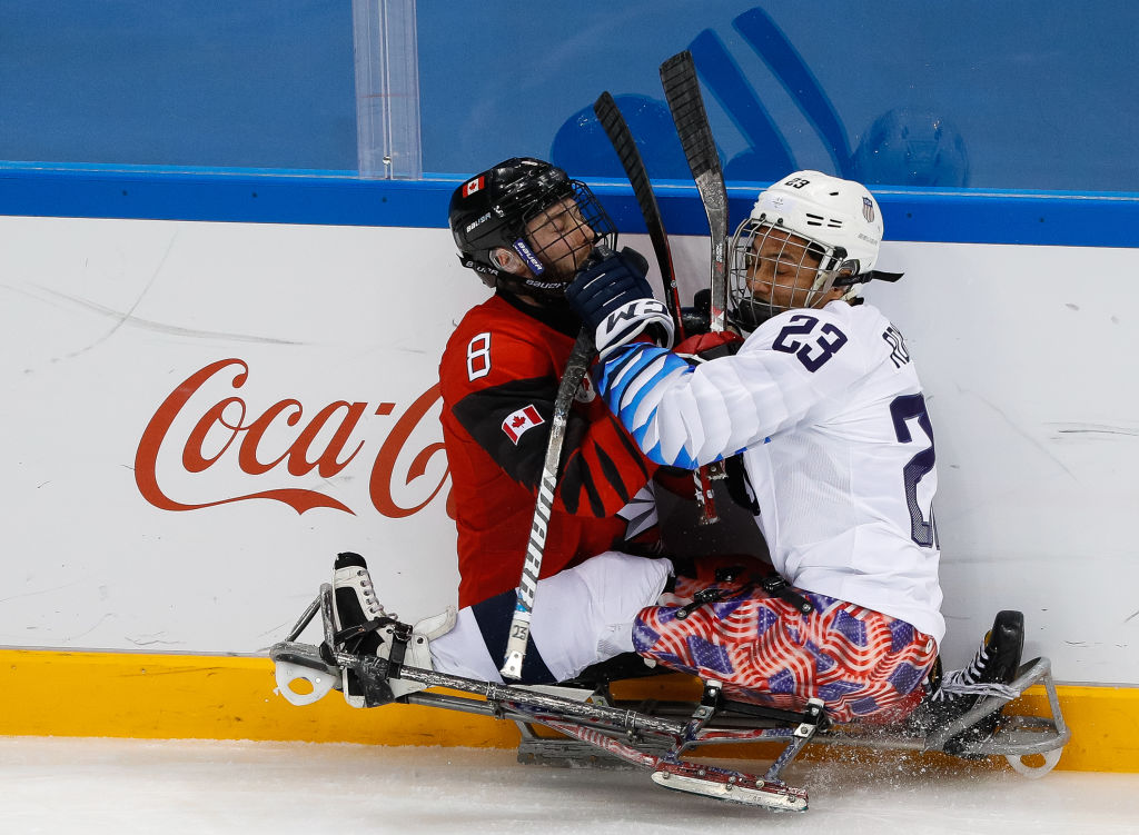 BATTLE ROYALE: (L) Tyler McGregor of Canada clashes for the puck with Rico Roman of the United States in the Para Ice Hockey gold medal game at 2018 PyeongChang 2018 Paralympic Winter Games. 