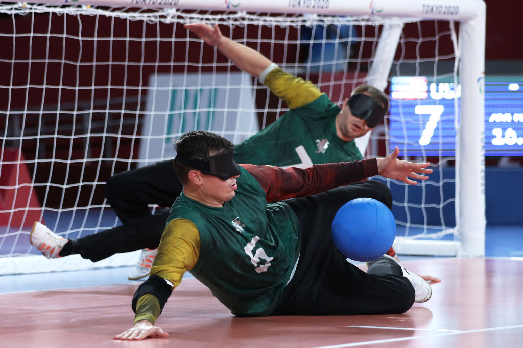 Lithuanian goalball players Mantas Brazauskis and Genrik Pavliukianec fall to the floor to block the net in the men's bronze medal match against Team USA at the Tokyo 2020 Paralympic Games.