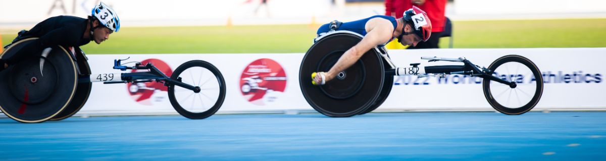 Two male wheelchair racers in a Para athletics event